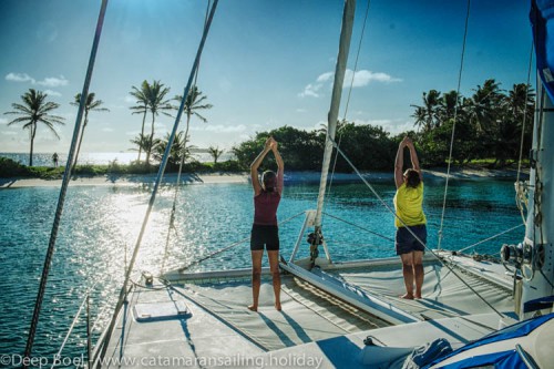 Doing Yoga on the deck of Yemaya. Yemaya is anchored in Salt whistle bay